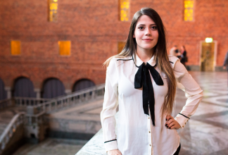 Genesis Davila in front of a brick wall