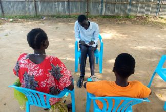 Case worker documenting a rape case outside South Sudan